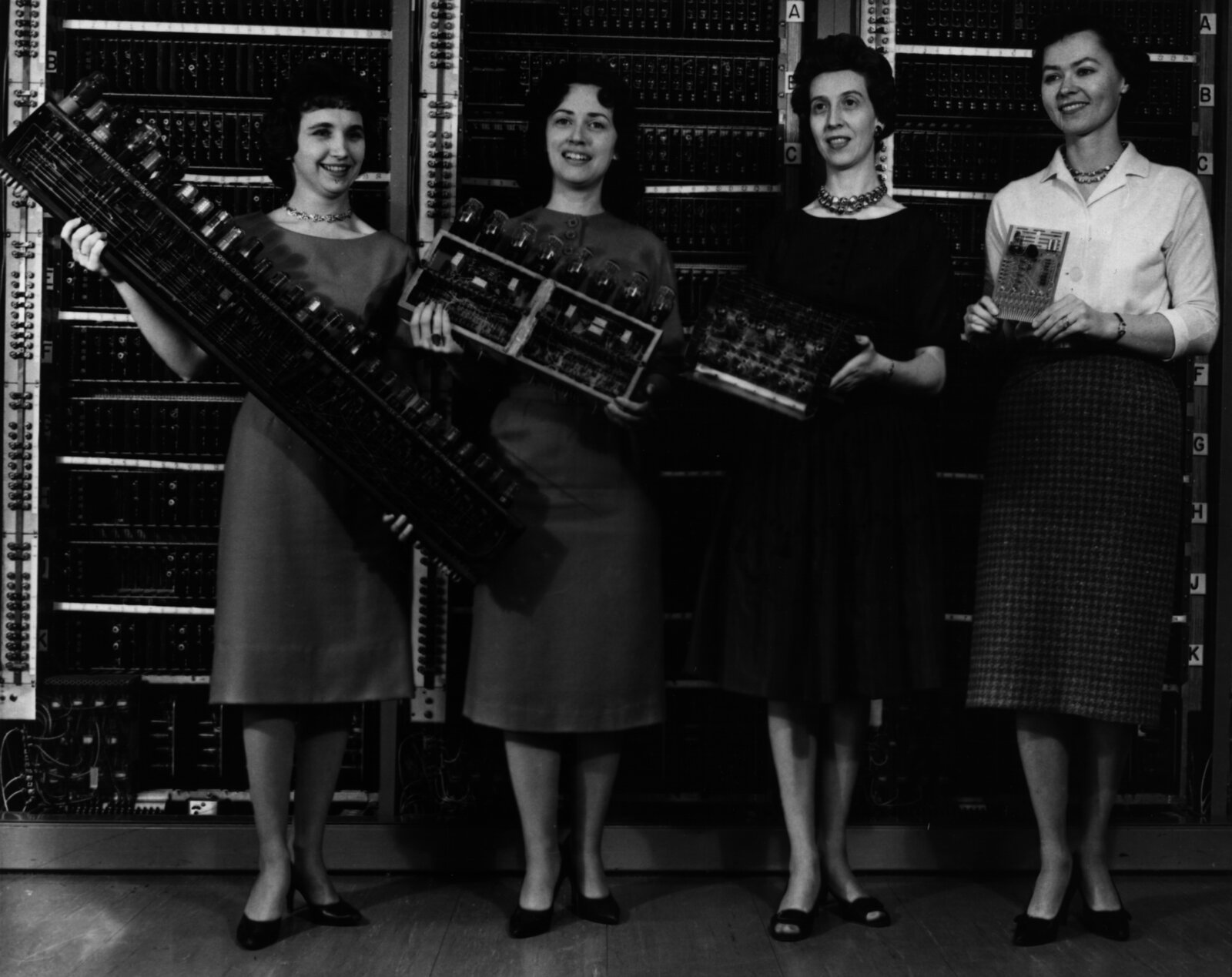 Four generations of computing in four hands. Left to right: Patsy Simmers holds an ENIAC board, Gail Taylor an EDVAC board, Milly Beck an ORDVAC board, and Norma Stec a BRLESC-I board. The progression from a dinner-plate-sized ENIAC panel to a pocket-sized transistorized board took less than two decades. U.S. Army photo, ARL Technical Library, public domain.
